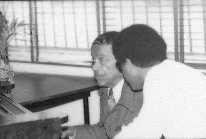 Claude Hopkins Working with a Student at the Piano