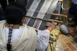 The weaving woman at her loom, showing us how scarves are made.